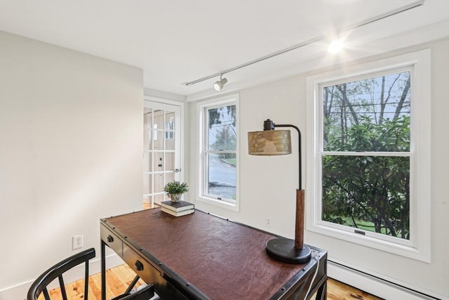 office area featuring track lighting and a baseboard heating unit