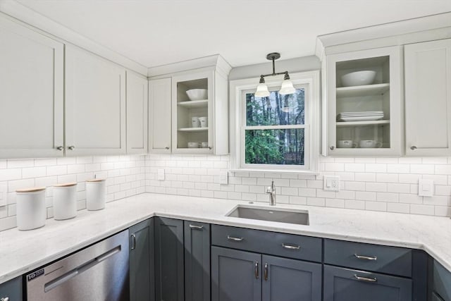 kitchen featuring a sink, decorative backsplash, white cabinets, and dishwasher
