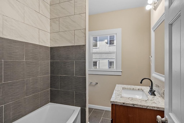 full bathroom with vanity and baseboards