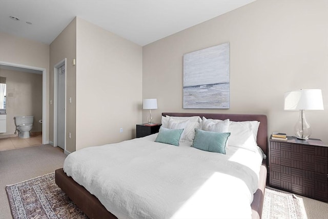 bedroom with carpet floors and ensuite bathroom
