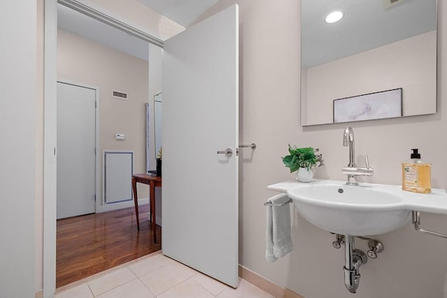 bathroom with tile patterned flooring and a sink