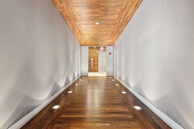 hall featuring wooden ceiling, baseboards, and recessed lighting