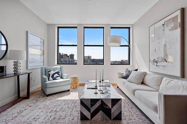 living room with plenty of natural light, wood finished floors, and baseboards
