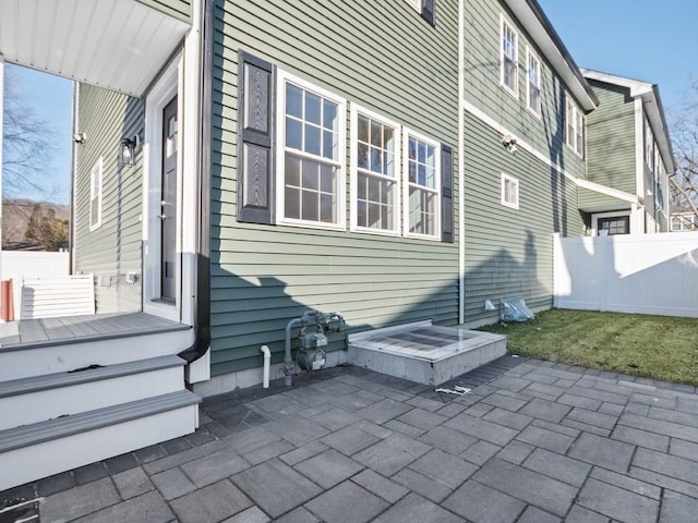 view of side of property with a patio