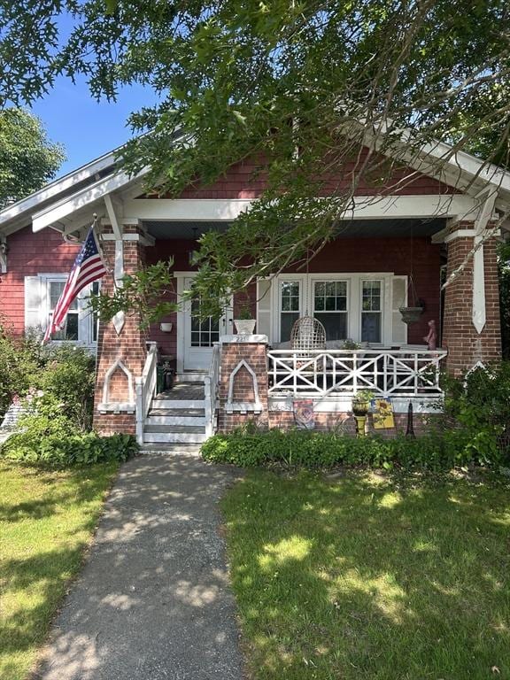 221 Summer St, Dighton, MA 02764 - view of front of property featuring a porch, brick siding, and a front yard