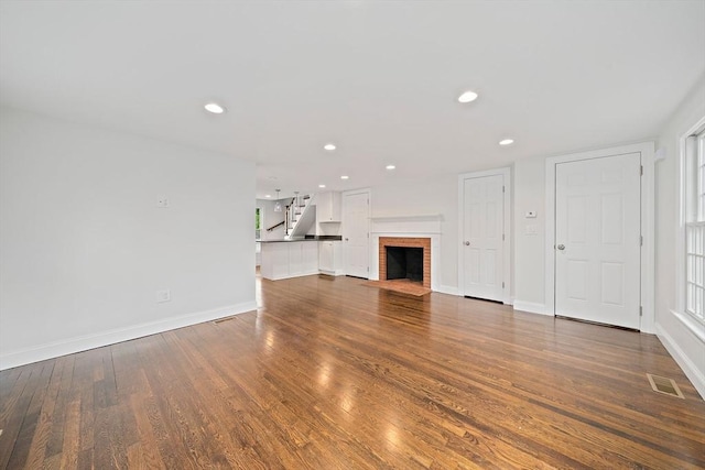 24 Summer St Unit A, Kingston, MA 02364 - unfurnished living room with wood finished floors, recessed lighting, a fireplace, and stairway