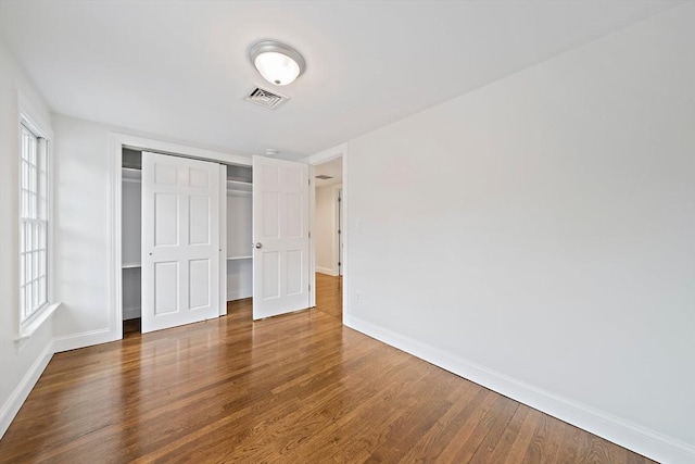 24 Summer St Unit A, Kingston, MA 02364 - unfurnished bedroom with wood finished floors, a closet, and multiple windows