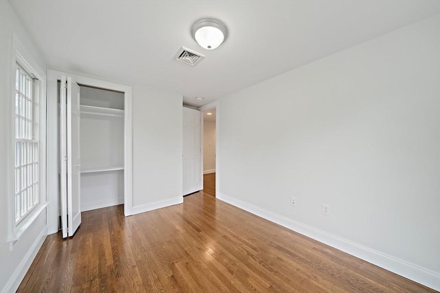 24 Summer St Unit A, Kingston, MA 02364 - unfurnished bedroom with wood finished floors, a closet, and multiple windows