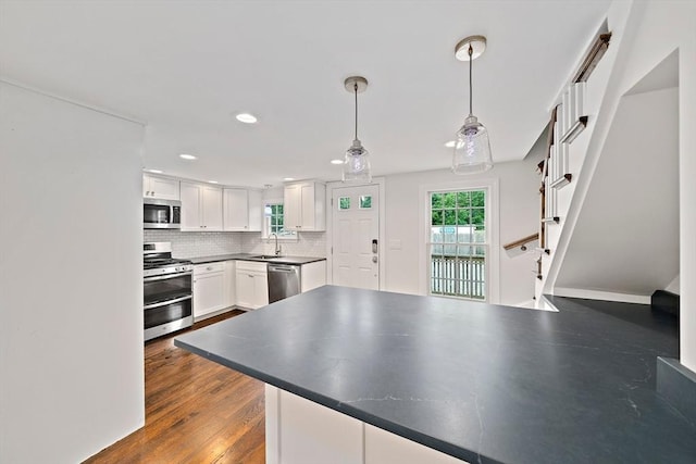 24 Summer St Unit A, Kingston, MA 02364 - kitchen with appliances with stainless steel finishes, backsplash, white cabinetry, recessed lighting, and hanging light fixtures