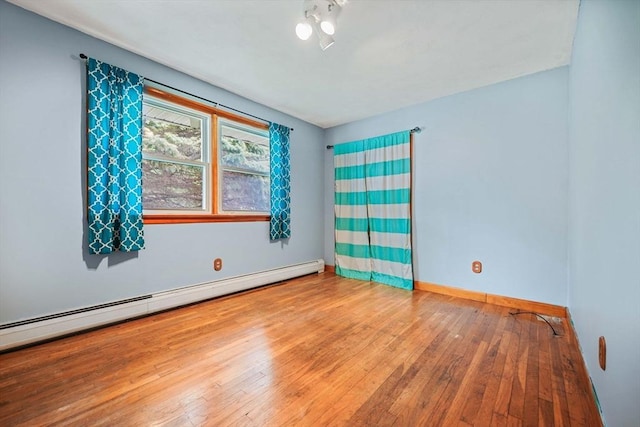 20 Roy St, Fairhaven, MA 02719 - spare room with baseboard heating, wood-type flooring, and baseboards