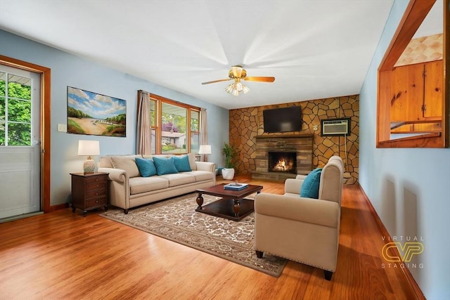 20 Roy St, Fairhaven, MA 02719 - living room featuring wood finished floors, baseboards, a fireplace, a ceiling fan, and a wall unit AC