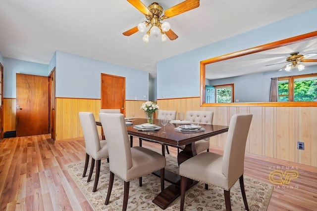 20 Roy St, Fairhaven, MA 02719 - dining area with wainscoting, a ceiling fan, wooden walls, and light wood finished floors
