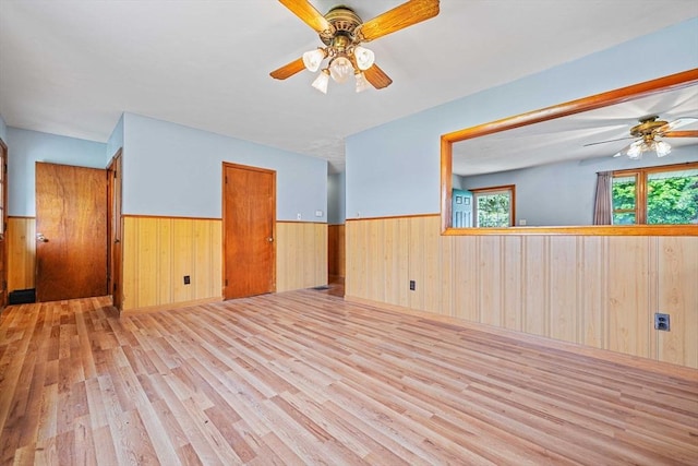 20 Roy St, Fairhaven, MA 02719 - unfurnished room featuring ceiling fan, a wainscoted wall, wood finished floors, and wooden walls