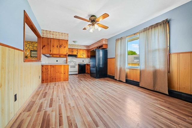 20 Roy St, Fairhaven, MA 02719 - kitchen with black appliances, brown cabinetry, a wainscoted wall, light countertops, and under cabinet range hood