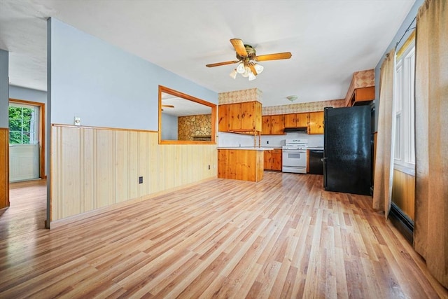 20 Roy St, Fairhaven, MA 02719 - kitchen with freestanding refrigerator, white gas range, light wood-style floors, a wainscoted wall, and light countertops