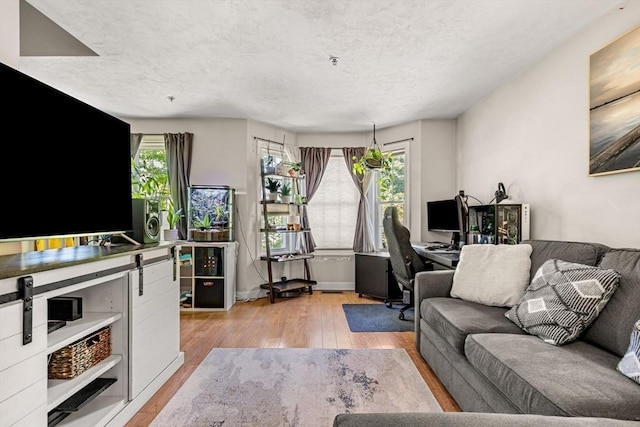 97 Hildreth St Unit 3, Lowell, MA 01850 - living area featuring wood-type flooring, a textured ceiling, and a desk