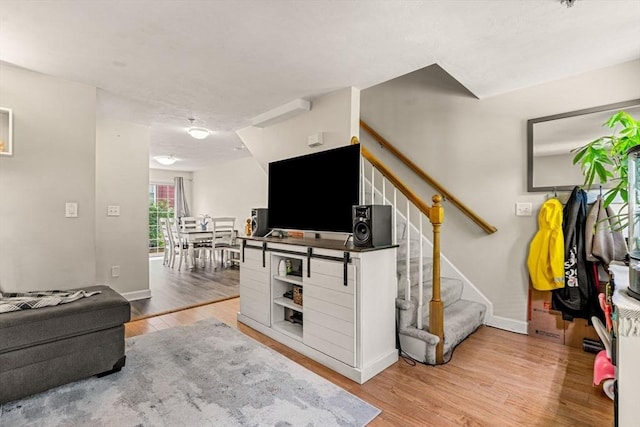 97 Hildreth St Unit 3, Lowell, MA 01850 - living room featuring stairs, wood finished floors, and baseboards