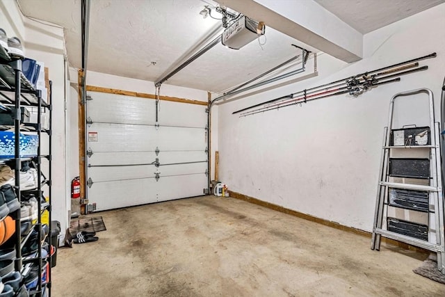 97 Hildreth St Unit 3, Lowell, MA 01850 - garage featuring a garage door opener and baseboards