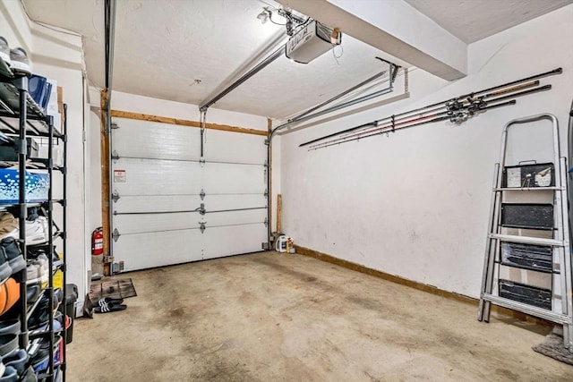 97 Hildreth St Unit 3, Lowell, MA 01850 - garage featuring a garage door opener and baseboards