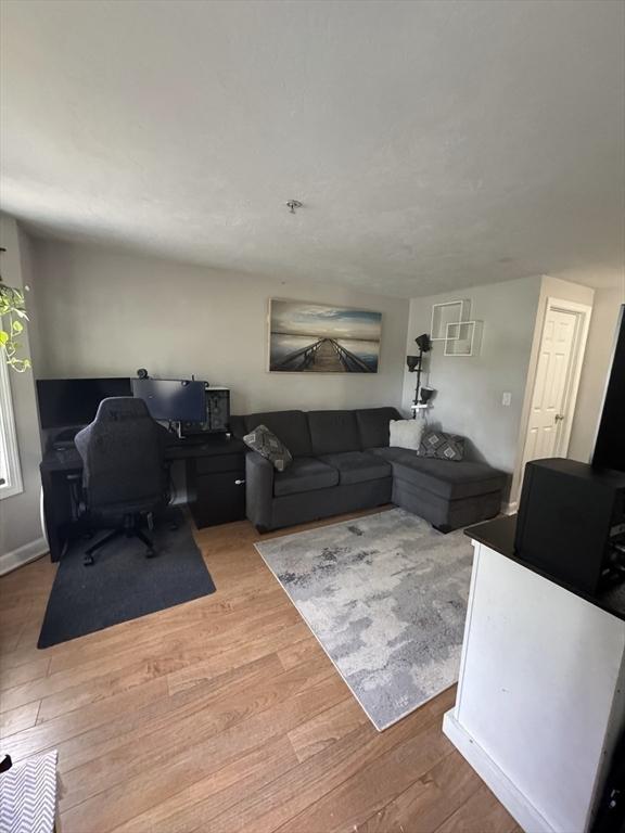 97 Hildreth St Unit 3, Lowell, MA 01850 - living room with wood finished floors and a desk