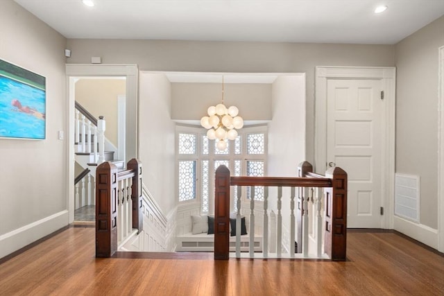 stairs with baseboards, visible vents, wood finished floors, a chandelier, and recessed lighting