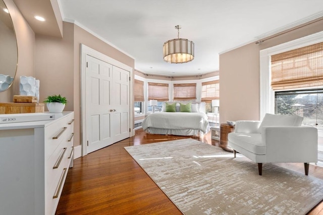 bedroom featuring ornamental molding and dark wood-type flooring