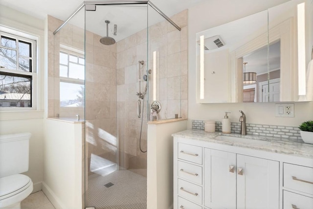 full bath featuring toilet, a shower stall, vanity, and tile patterned floors