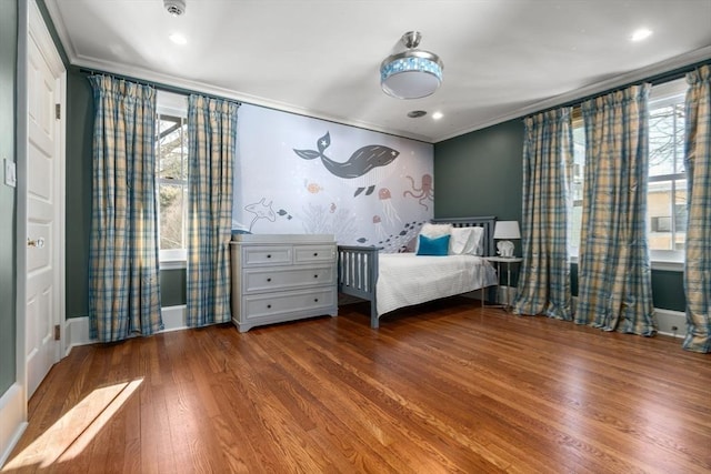 unfurnished bedroom featuring ornamental molding, recessed lighting, wood finished floors, and baseboards