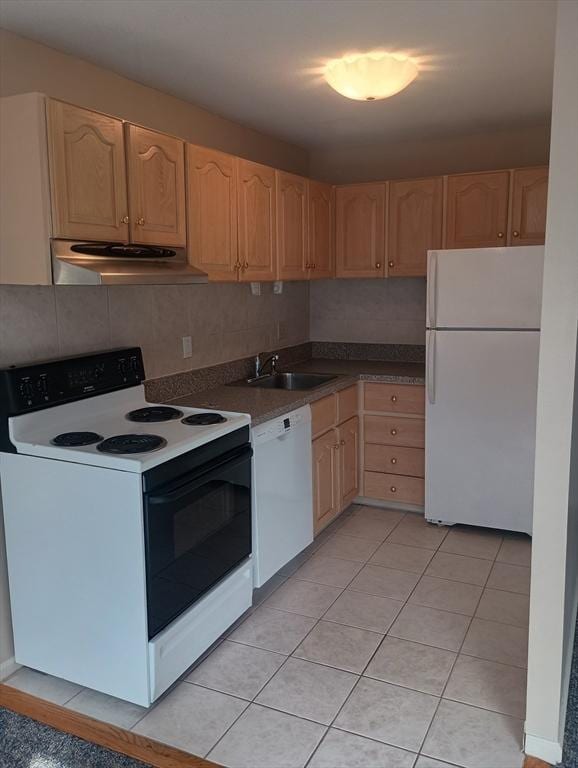 kitchen with light brown cabinets, range hood, white appliances, and a sink