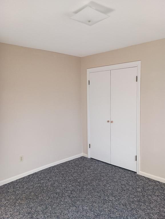 unfurnished bedroom with baseboards and carpet floors