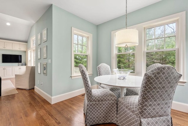 dining space with wood finished floors and baseboards