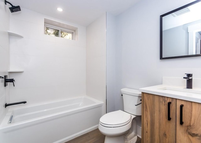 full bathroom with washtub / shower combination, vanity, toilet, wood finished floors, and visible vents
