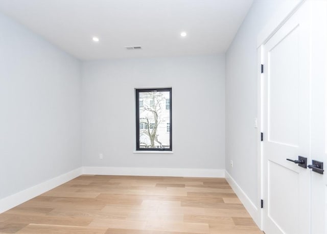 empty room featuring visible vents, recessed lighting, baseboards, and light wood-type flooring