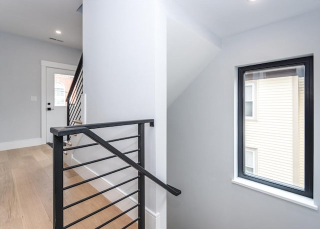 stairway featuring recessed lighting, baseboards, visible vents, and wood finished floors