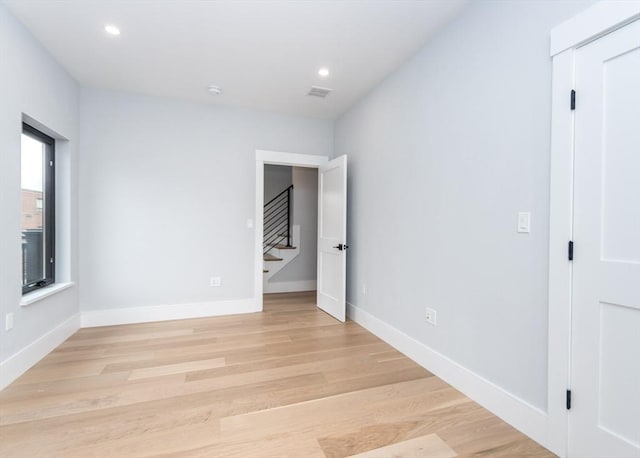 unfurnished bedroom featuring light wood-style floors, recessed lighting, baseboards, and visible vents