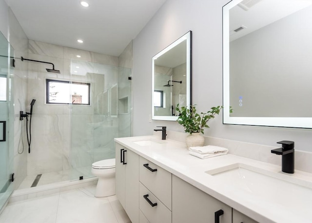 full bathroom featuring a sink, a marble finish shower, and toilet
