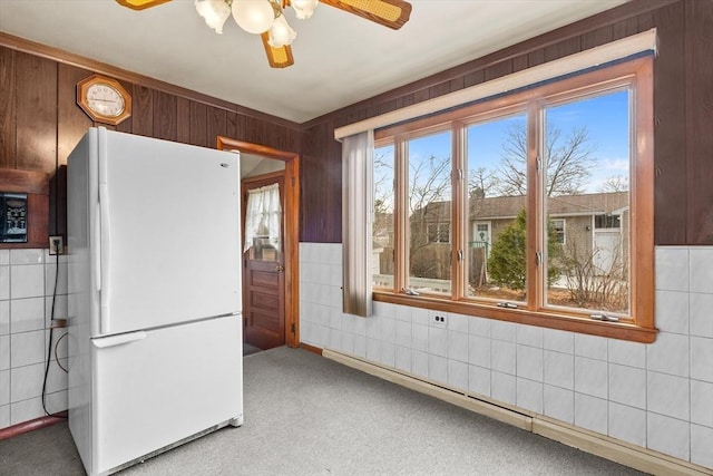 kitchen featuring a ceiling fan, tile walls, carpet flooring, and freestanding refrigerator