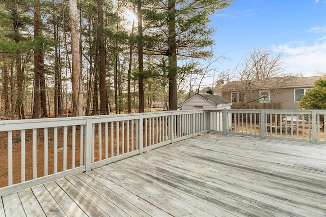 wooden terrace featuring an outbuilding