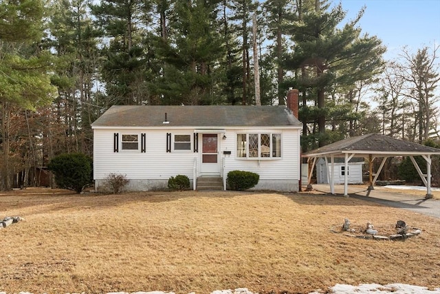 ranch-style home with a carport, entry steps, and a chimney