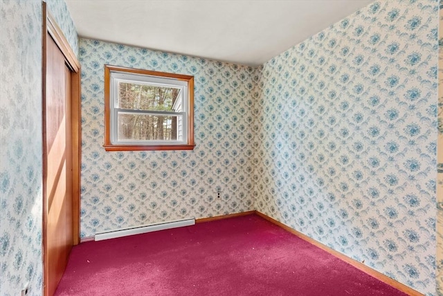 empty room featuring a baseboard radiator, carpet flooring, and wallpapered walls