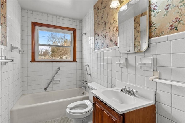 full bath with vanity, tile walls, toilet, and a tub