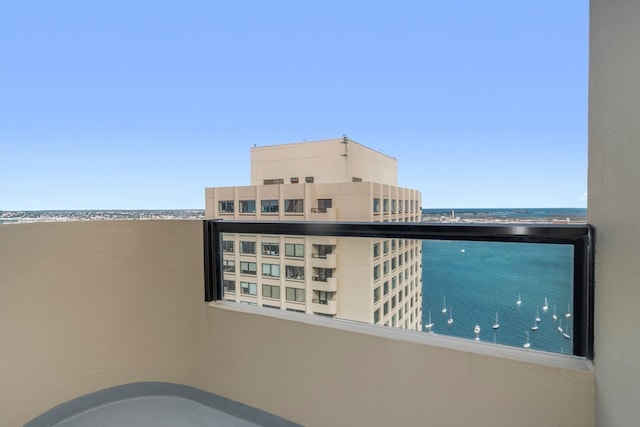 balcony featuring a water view and a beach view