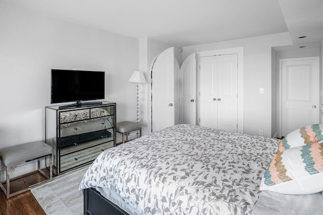 bedroom with a closet and hardwood / wood-style floors