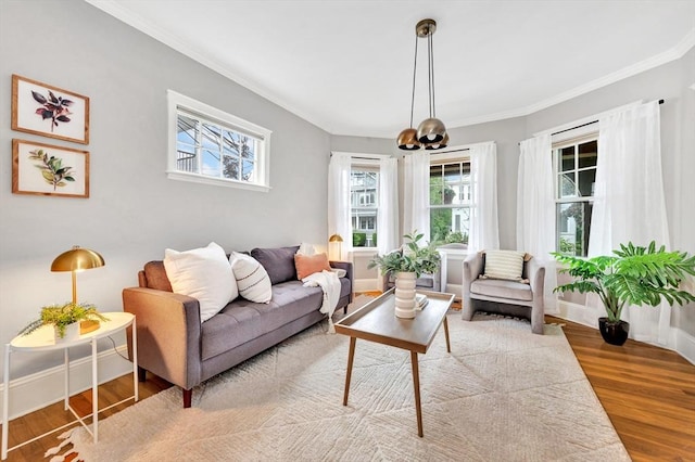 100 Melrose St Unit 100, Arlington, MA 02474 - living area with plenty of natural light, ornamental molding, wood finished floors, a chandelier, and baseboards