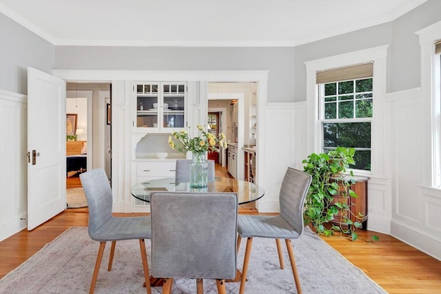 100 Melrose St Unit 100, Arlington, MA 02474 - dining area featuring a decorative wall, wood finished floors, ornamental molding, and a wainscoted wall