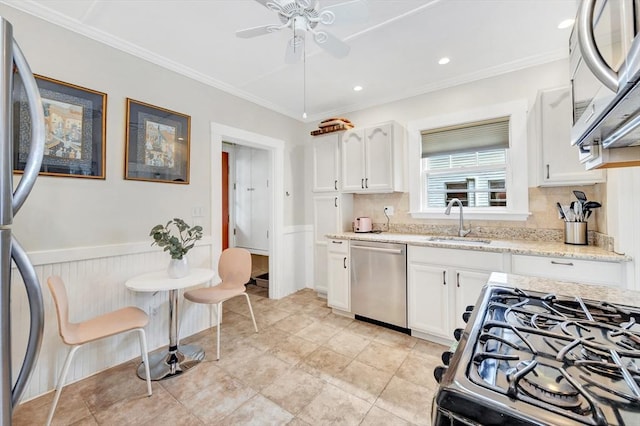 100 Melrose St Unit 100, Arlington, MA 02474 - kitchen featuring stainless steel appliances, a sink, ornamental molding, white cabinets, and ceiling fan