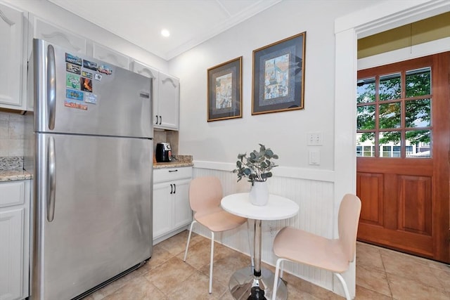 100 Melrose St Unit 100, Arlington, MA 02474 - dining space featuring a wainscoted wall and light tile patterned floors