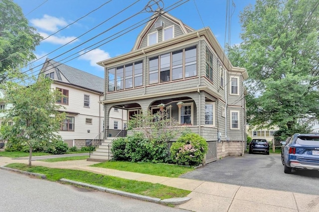 100 Melrose St Unit 100, Arlington, MA 02474 - view of front facade featuring a porch and asphalt driveway