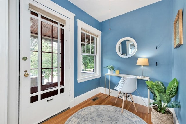 100 Melrose St Unit 100, Arlington, MA 02474 - doorway to outside featuring baseboards, wood finished floors, and a desk