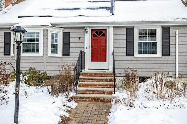 view of snow covered property entrance